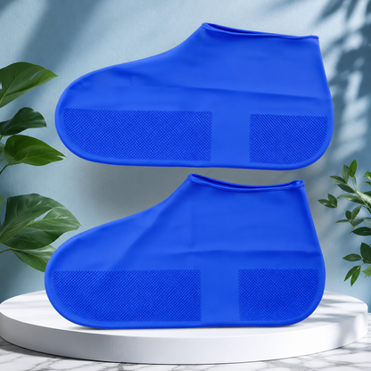 Reusable blue waterproof silicone rain shoe covers with non-slip sole on studio display