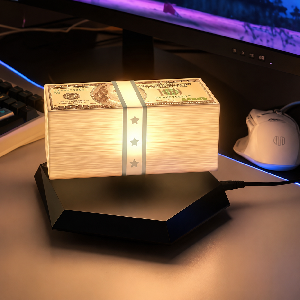 Stack of money on a stand with computer equipment in the background