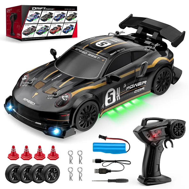 Toy race car with remote control, batteries, and accessories on a white background