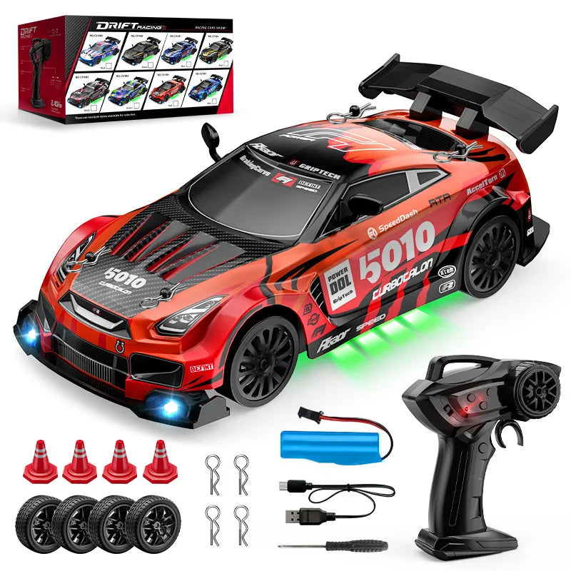 Red and black remote control car with accessories on a white background
