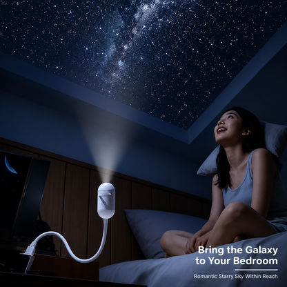 Woman sitting on a bed looking up at a starry sky projected onto the ceiling by a portable projector.